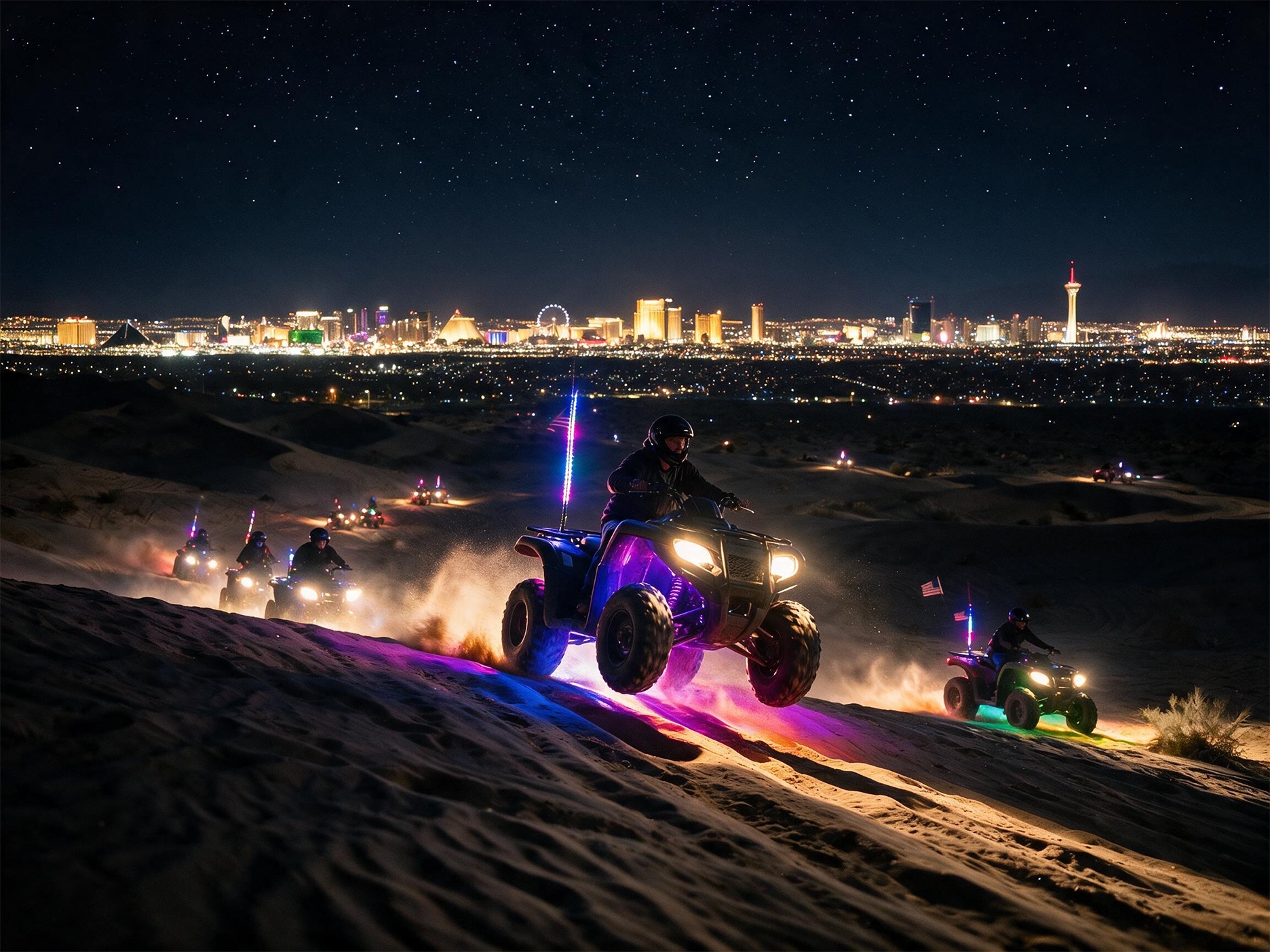 LED-lit ATVs cresting a dune with the Strip on the horizon